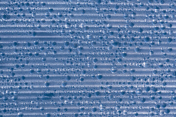 Plastic polycarbonate transparent background in drops of water condensate