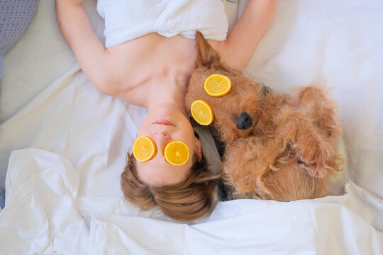 Woman and dog having spa day in hotel with cosmetics eye patches 