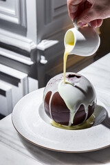 Chocolate ball with strawberries and mint with warm sweet milk