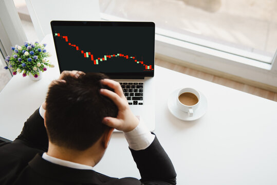 Sad businessman with market stock bar chart going down.