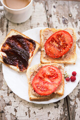 Toasts with liver sausage and tomatoes and plum jam and coffee 