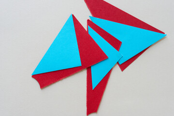 folded blue paper and red paper shapes