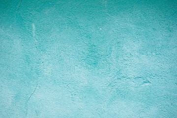 Decorative plaster of light blue color with small pimples, wall surface.