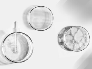 Blue gray cosmetic liquid on Petri dish with pipette. Tonic or toner serum gel swath. Mock up