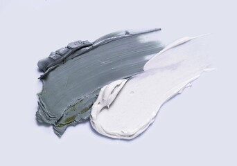 White gray cosmetic mask smudge sample texture. Mud, charcoal or  clay cleansing mask or face foam....