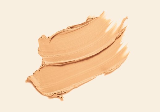 Foundation or bb cc cream and matte concealer texture swatch on beige background