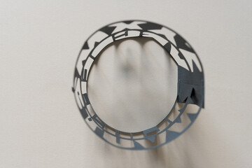 abstract paper object (rolled paper stencil with letters cutout, viewed from above, with abstract...