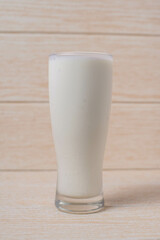 glass of milk on wooden table