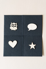 wood embellishments or ornaments on paper (owl, speech bubble, heart, and star) 