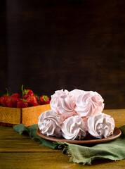 Homemade pink strawberry zephyr or marshmallow on a wooden table. Selective focus. the concept of delicious healthy natural food