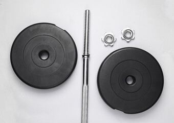 Disassembled barbell on a white background. Bodybuilding and fitness. Top view