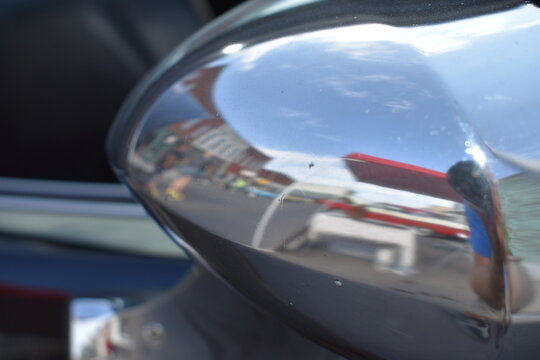 Reflection in the Chrome of a Car Mirror
