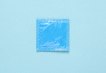 Blue condom packaging on a blue background