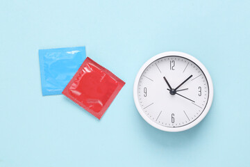 Clock with condoms on a blue background