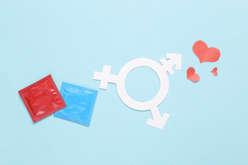 Transgender gender symbol with hearts and condoms on blue background