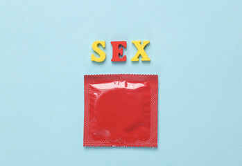 Red pack of condoms with the word sex on a blue background