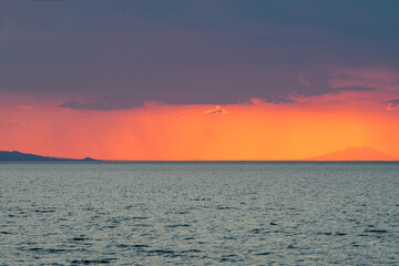 Dramatic sunset with vivid colors against the sea.
