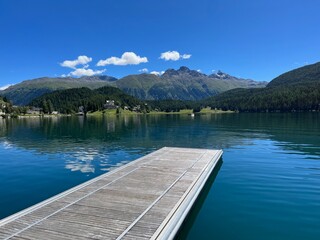 Wooden pier at St. Moritzersee in Graubuenden, Grisons, Switzerland.