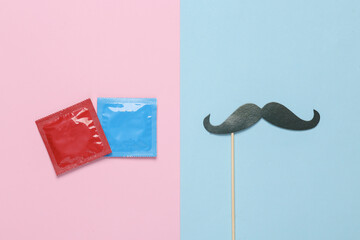 Packets of condoms with a mustache on a stick. Blue pink pastel background