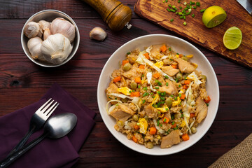Fried rice with chicken and vegetables in white plate.Top view
