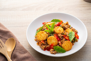 Stir fried basil with minced pork and eggs bean curd in white plate
