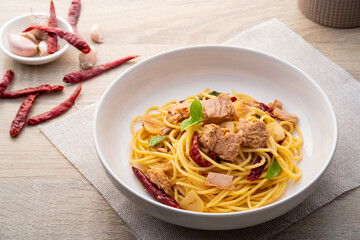 Canned tuna Spaghetti with Dried Chili and garlic in white plate.Fusion food