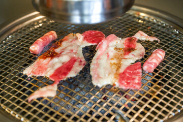 Grilled fat beef slices on Korean charcoal grill