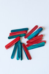 pile of blue and red wood sticks on a light background