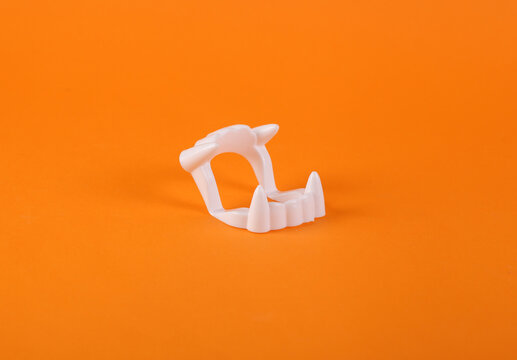 Vampire plastic jaw on orange background