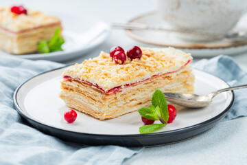 Two pieces of cake Napoleon on white plate. Russian cuisine, multi layered cake with pastry cream,...