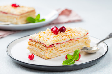 Two pieces of cake Napoleon on white plate. Russian cuisine, multi layered cake with pastry cream, close up view