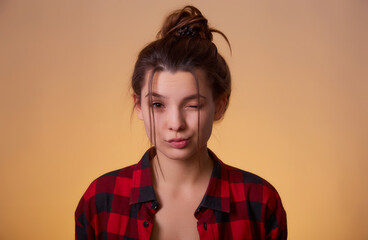 Close up portrait of playful and sweet woman showing duck face and giving wink isolated yellow background with copy space for text