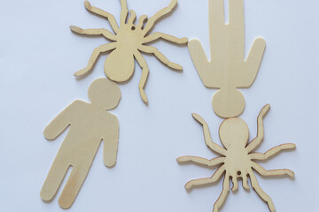 ornamental wooden spiders and figures on a light background