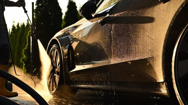 Men Washing His Car Using Pressure Washer