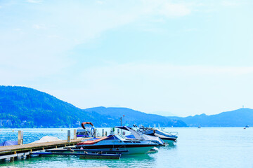 pier and motor boats on a mountain lake. beautiful view of the lake and the mountains