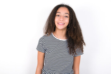 young beautiful girl with afro hairstyle wearing striped t-shirt over white wall with nice beaming smile pleased expression. Positive emotions concept