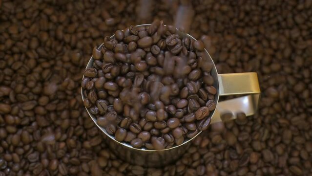 4K-Motion Shot of Falling Roasted Coffee Beans into Ground Coffee 