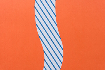 orange paper and paper card with blue and white stripes