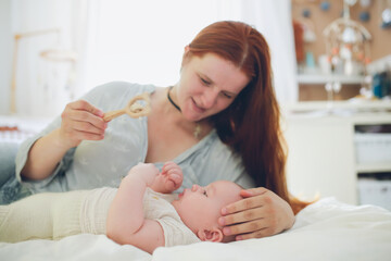 Plus size mom play with chubby baby 6 months in woolen eco diapers,