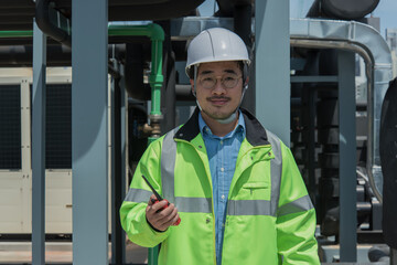 worker on system plant. Portrait engineer in safety uniform with hand hold radio communication  on...
