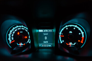 car speedometer that shows details of the car, speed, distance, etc., on a dark background. park...