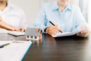 Real estate brokers or real estate agent with client or architect team Discussions about contracts , Saving money to invest in house or property in the future. Business property Concept.