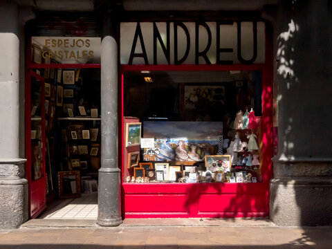 Barcelona, Spain - September 8, 2018 - Antique store windows with paintings