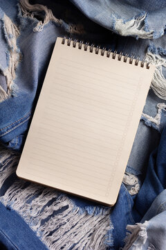 Blue jeans denim background texture. Torn jeans fabric material surface