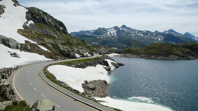 A handheld footage of Grimsel Pass road, mountain and Totensee Lake in afternoon. The pass connects the Haslital, the upper valley of the river Aare, with the upper valley of the Rh&ocirc;ne.