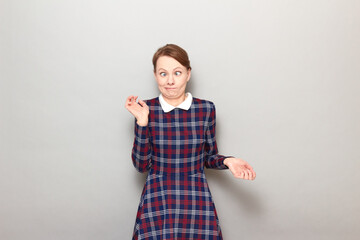 Portrait of funny confused young woman making silly goofy face