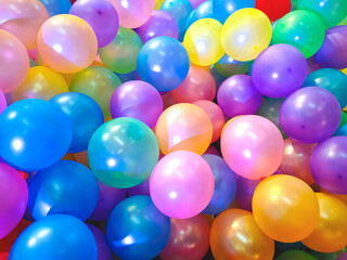 Fototapeta na wymiar Background of many colorful balloons on the floor in playground area at shopping mall