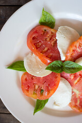 Caprese salad. Tomatoes and mozzarella with basil