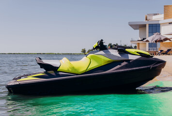 Yellow white water scooter is in the blue sea