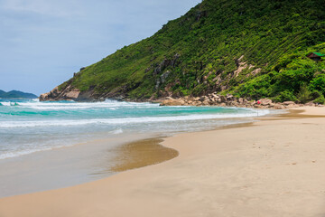 Fototapeta na wymiar Sandy beach and ocean waves. Praia do Rio das Pacas in Brazil